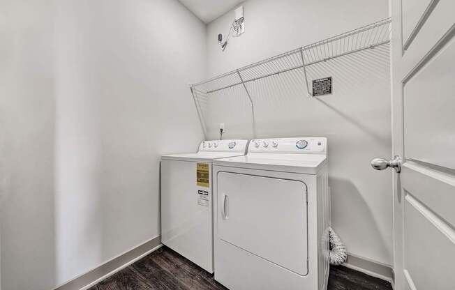 a washer and dryer in a laundry room with a door