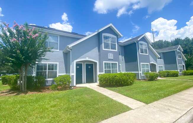 Apartment building exterior surrounded by native landscaping