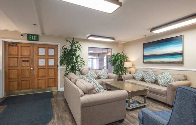 a living room with couches and chairs and a table at Huntington Terrace North Senior, Huntington Beach