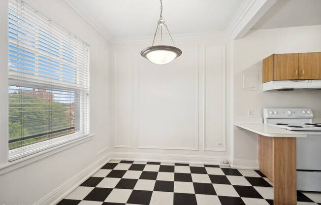 a kitchen with a checkered floor and a window at The Embassy in St. Louis, 63108