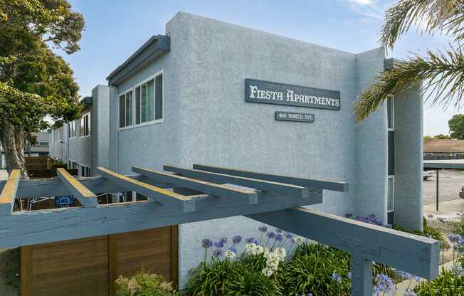 A building with a sign that says "Fifth Apartments" on it.