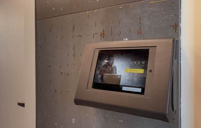 A wall-mounted television displays an advertisement for a luxury product.