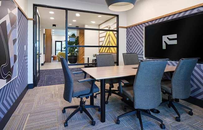 a conference room with a table and chairs