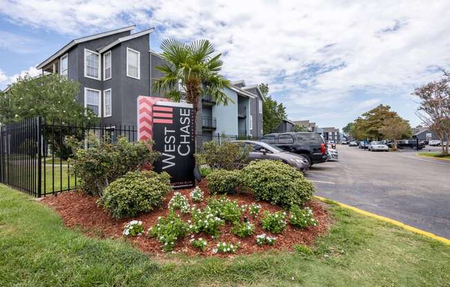 Westchase Apartments in Harvey LA photo of the property's monument sign with flowers