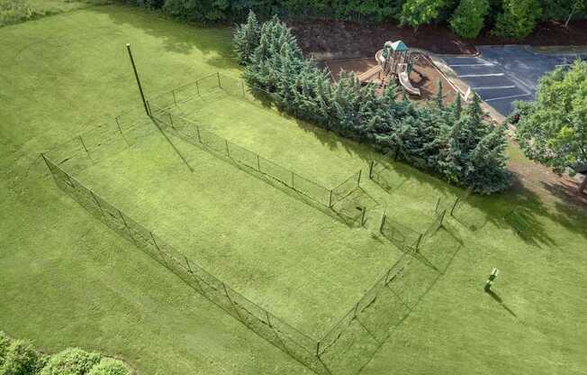 A large open grassy area with a maze in the middle.