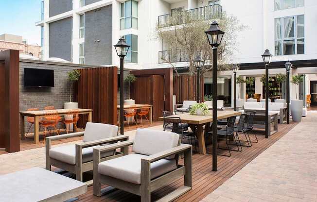 A patio with a table and chairs is surrounded by buildings.