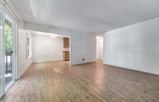 a living room with hardwood floors and white walls