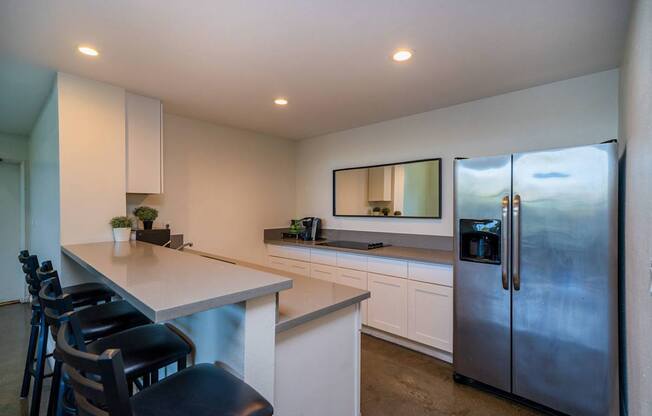 A modern kitchen with a large island and stainless steel appliances.