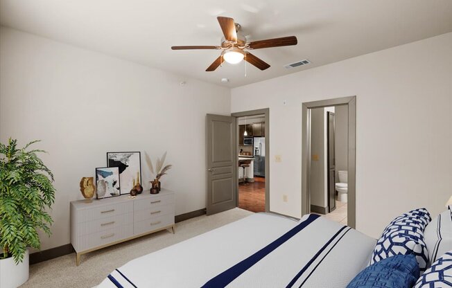 a bedroom with a bed and a ceiling fan