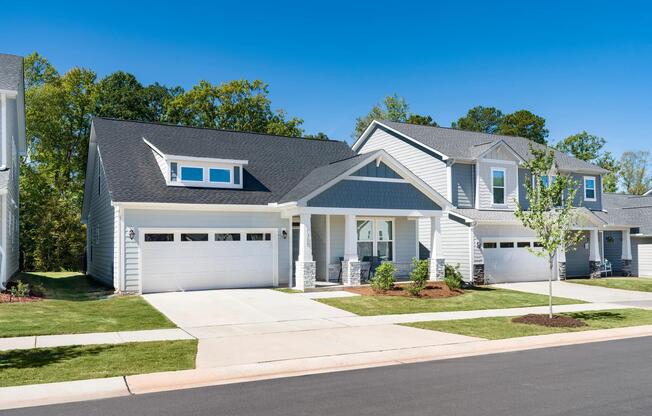 Select single-story homes offer the convenience of main-level living, featuring attached garages, covered front porches, and thoughtfully designed layouts within a professionally managed rental home community.