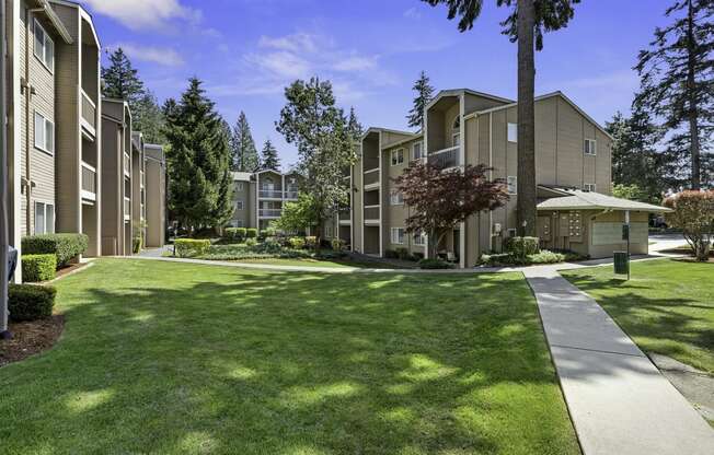 Apartment Buildings Surrounded by Grassy Area with Trees at Park 210 Apartment Homes, Washington, 98026