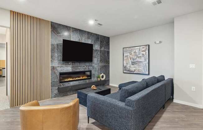 a living room with a couch and a chair and a fireplace