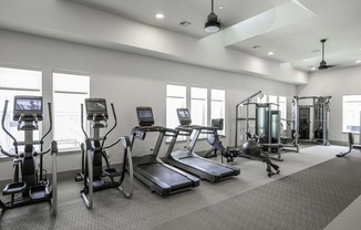 Fitness studio with spin bikes and cardio equipment.