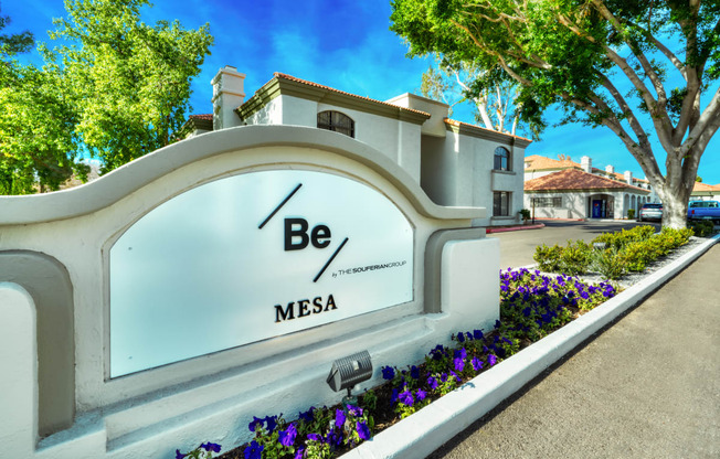 a sign that says be mesa in front of a building