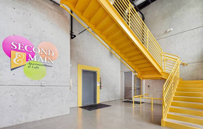 A staircase with a yellow railing and steps leads up to a door.