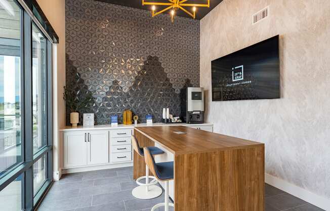 a kitchen with a wooden counter and a tv on the wall