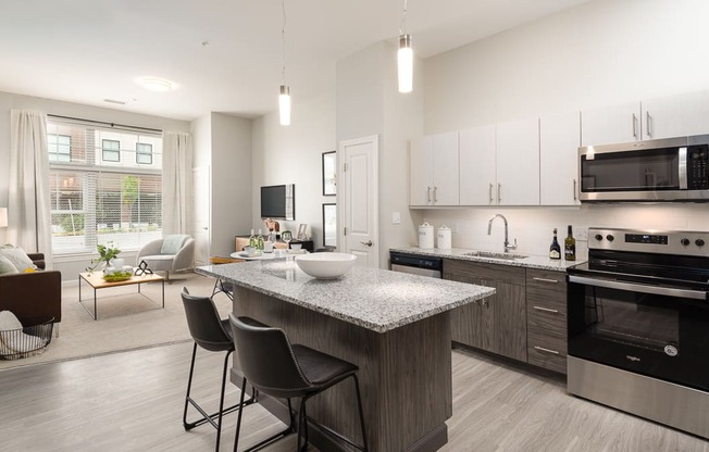 One bedroom den kitchen with granite counters, stainless appliances and large living room window