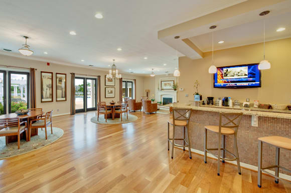 Clubhouse with bar area; flat screen TV; tables and chairs; fireplace