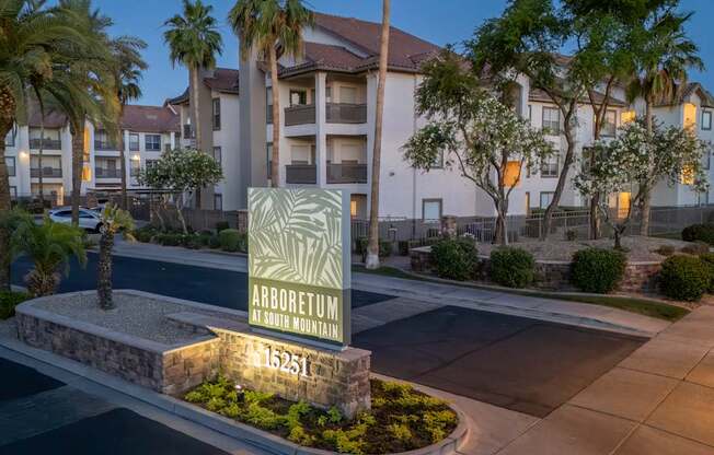 A sign for Arboretum at 115251 is displayed in front of a building.
