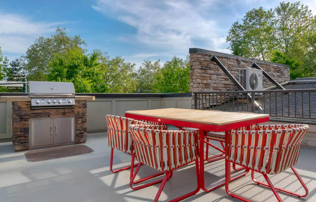 a patio with a table and chairs and a grill at Delano, Redmond Washington