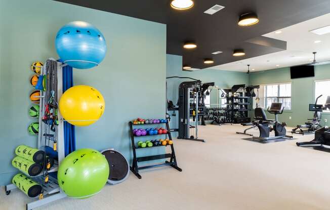 a large fitness room with weights and other exercise equipment