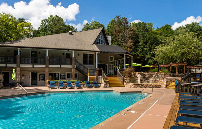 a large swimming pool in front of a house