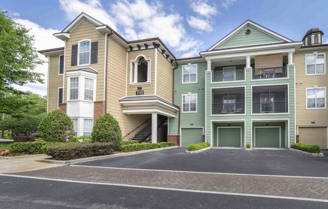 the view of two apartment buildings with a parking lot