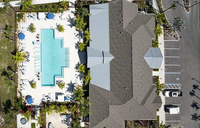 a birds eye view of a pool and a building with trees