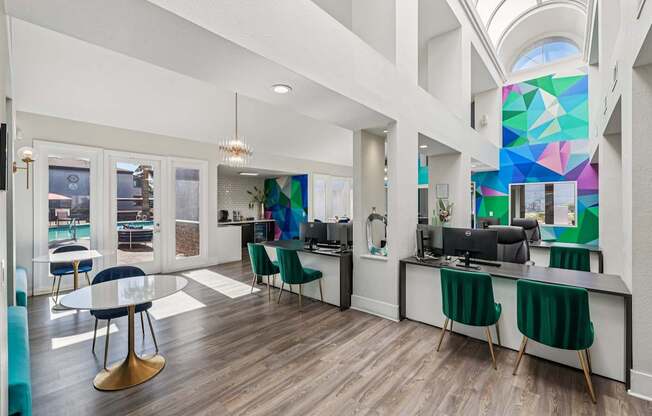 A modern office space with a glass ceiling and a large mural on the wall.
