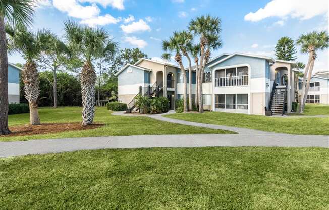 a home with palm trees in front of it