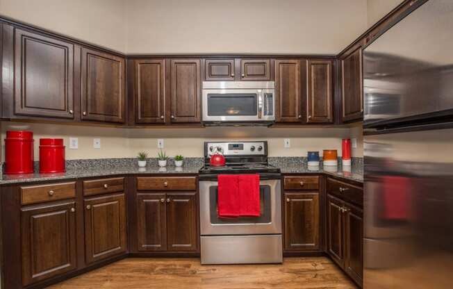 Kitchen space with wooden cabinets at The Belmont by Picerne, Las Vegas, NV, 89183