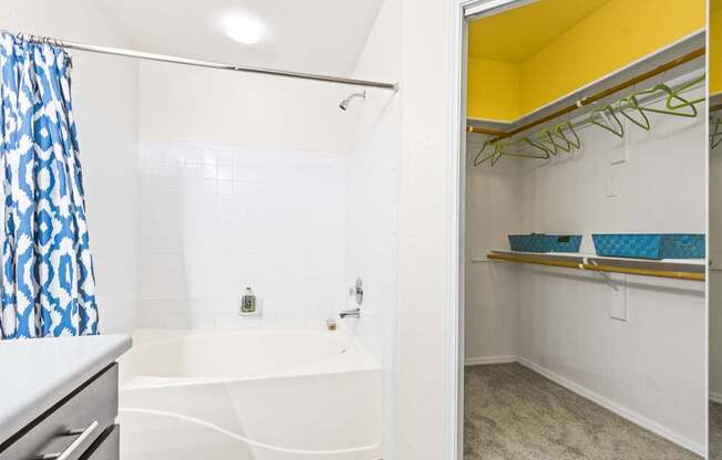 a bathroom with a tub and a shower and a sink