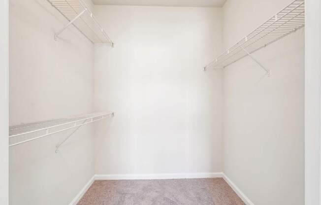 A large walk-in closet with shelves.