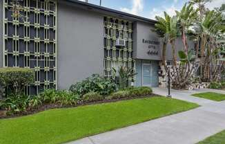 a building with a lawn and trees in front of it