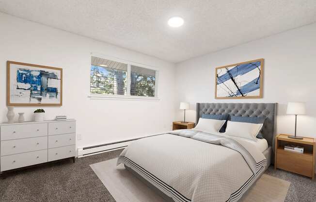 furnished bedroom with white walls and carpeting and a bed