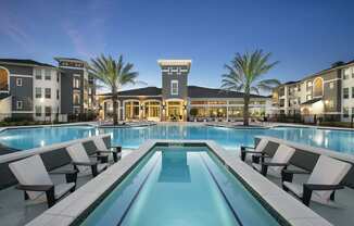 Pool surrounded by clubhouse and buildings