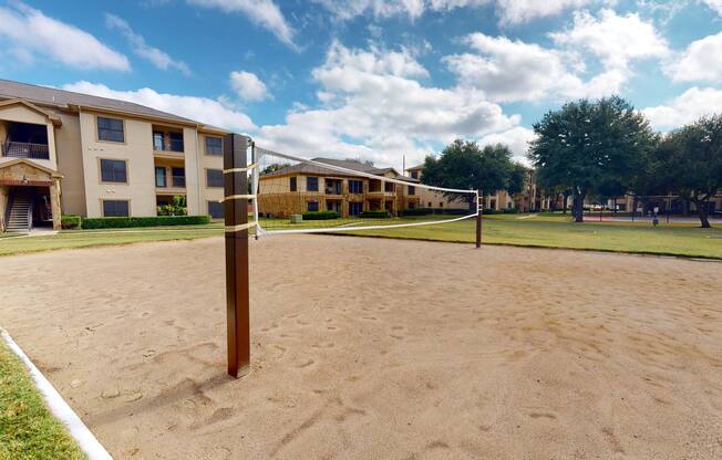 outdoor sand volleyball court at The Canyons Apartments, Fort Worth, 76116