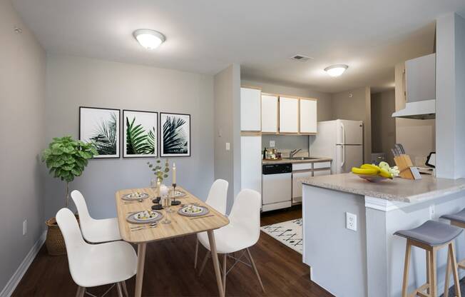 an open kitchen and dining room with a table and chairs