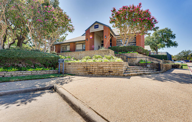 a brick retaining wall in front of a house