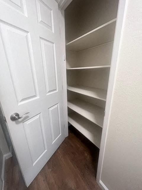 a white closet with shelves and a white door