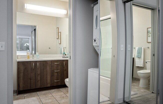 a bathroom with a shower toilet and sink and a mirror