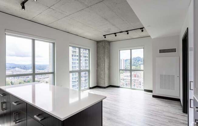 A large, empty room with a long counter and a view of the city.