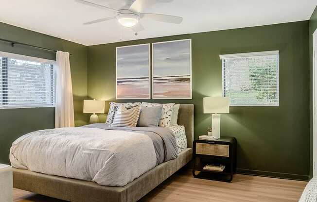 Bedroom view with 2 windows and ceiling fan.