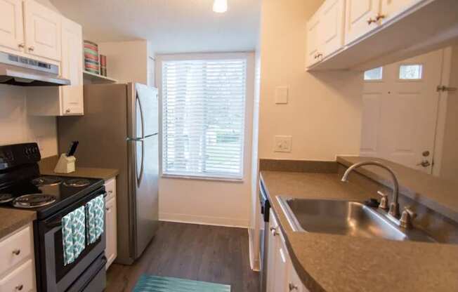 an open kitchen with granite counter tops and stainless steel appliances