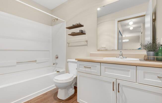 a white bathroom with a toilet and a sink