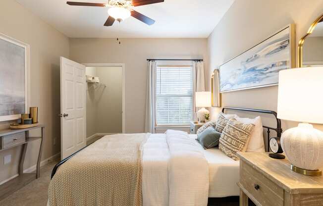 a bedroom with a large bed and a ceiling fan