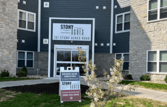 a sign in front of a building that says story apartments