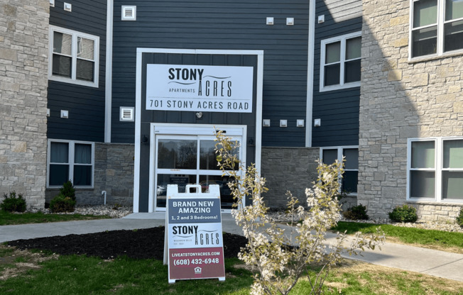 a sign in front of a building that says story apartments