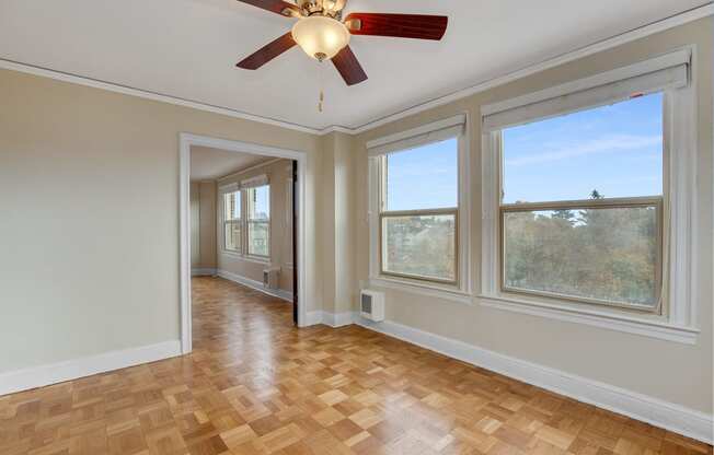 Living Room with Spacious Area, Overzied Windows, Wood-Style Flooring, and Ceiling Fan at Malloy Apartment Homes, Seattle, 98105