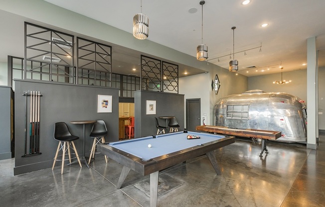 The Cleo Apartments Resident Game Lounge with Shuffleboard, Billiards Table, and Various Seating Areas